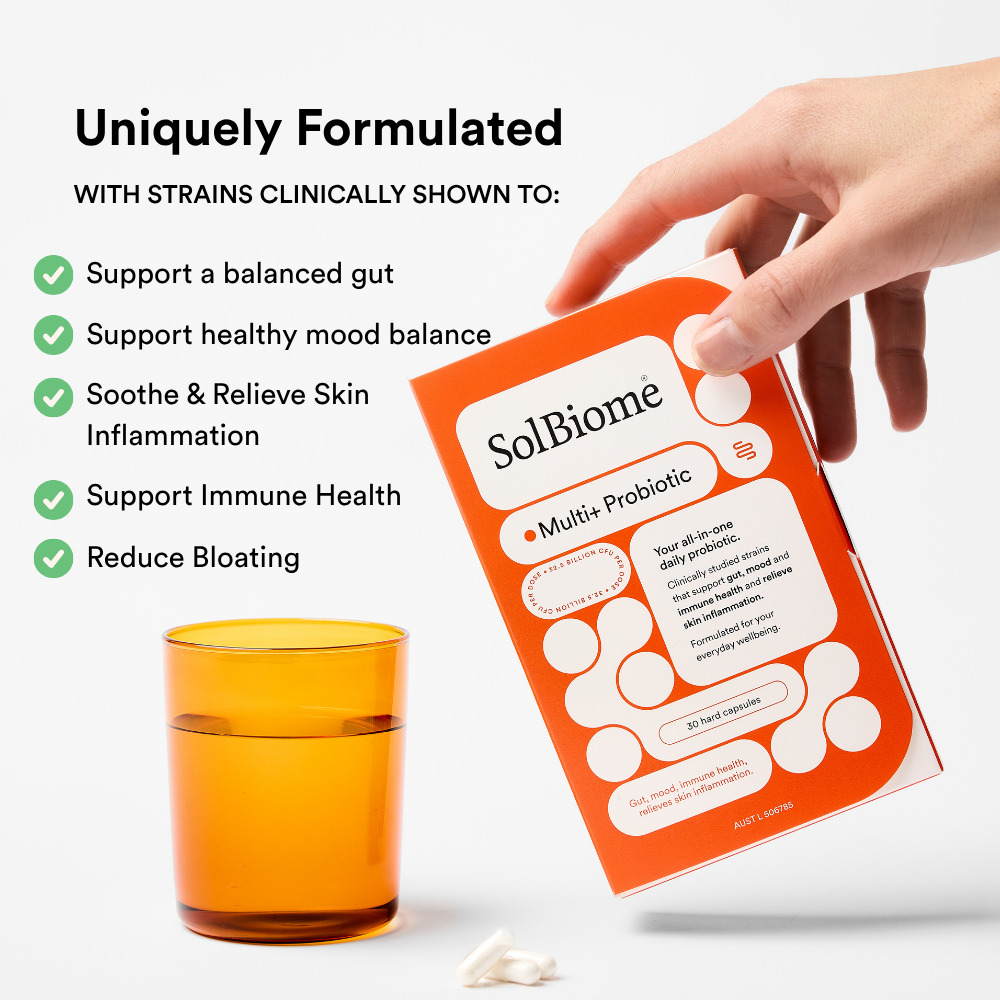 SolBiome multi-probiotic package with a hand holding it, glass of water, and text highlighting benefits on a white background.